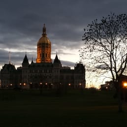 A view of the Capitol building while the sun sets A view of the Capitol building while the sun sets