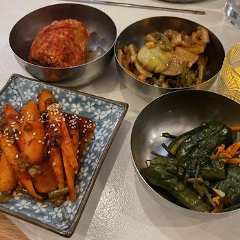 ANJU - Panchan from left to right: Kimchi, Soy-Brined Chayote, Carrot Kkakdugi, Pickled Cucumbers - Korean Near Me - Washington, DC, District of Columbia