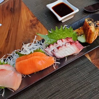 O-Ku - Sashimi (left to right: yellow fin tuna, salmon, octopus, and eel) - Sushi Bars Near Me - Raleigh, North Carolina O-Ku - Sashimi (left to right: yellow fin tuna, salmon, octopus, and eel) - Sushi Bars Near Me - Raleigh, North Carolina
