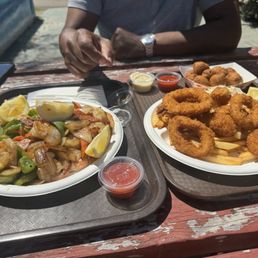 Grilled peeled shrimp place and seafood combo (shrimp, calamari, scallops). Also hush puppies