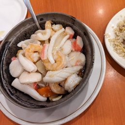 a pan of food and a plate of rice