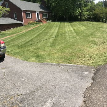 C.L. Landscaping & Turf Management - a car parked in front of a house - Lawn Services Near Me C.L. Landscaping & Turf Management - a car parked in front of a house - Lawn Services Near Me
