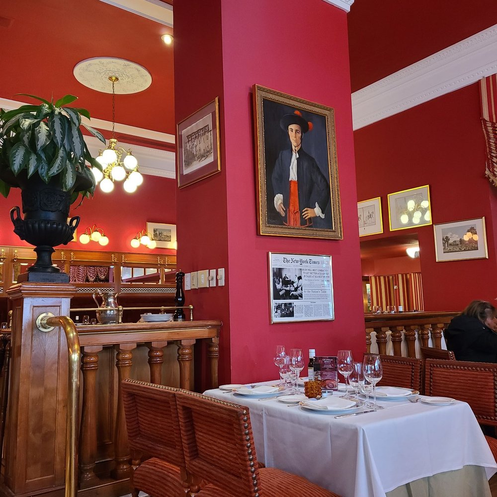 Taberna del Alabardero - View of part of the restaurant with a painting of a handsome Spaniard. - Spanish Near Me - Washington, DC, District of Columbia