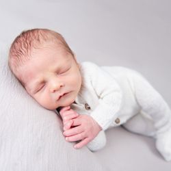 Adorable Art Photography - Newborn baby boy wearing white knit outfit - Michelle Harmon Queen Creek Arizona Photographer