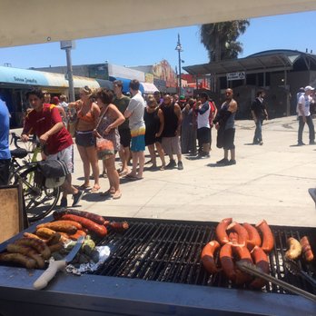 Sausage Masters - a large group of people standing around a bbq - Street Vendors Near Me Sausage Masters - a large group of people standing around a bbq - Street Vendors Near Me