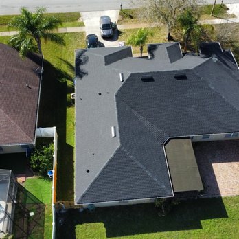 Image roofing - Finished roofing project done with 50 year shingle Tamco titan xt drone view - Roofing Near Me