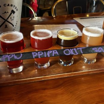 Grand Canyon Brewing + Distillery - Beer Flight; Prickly Pear Wheat Ale, Prickly Pear IPA, Old Trail Ale, & Cranberry-Orange Sour - American Near Me - Williams, Arizona Grand Canyon Brewing + Distillery - Beer Flight; Prickly Pear Wheat Ale, Prickly Pear IPA, Old Trail Ale, & Cranberry-Orange Sour - American Near Me - Williams, Arizona
