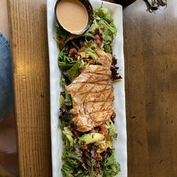a plate of salad and a bottle of beer