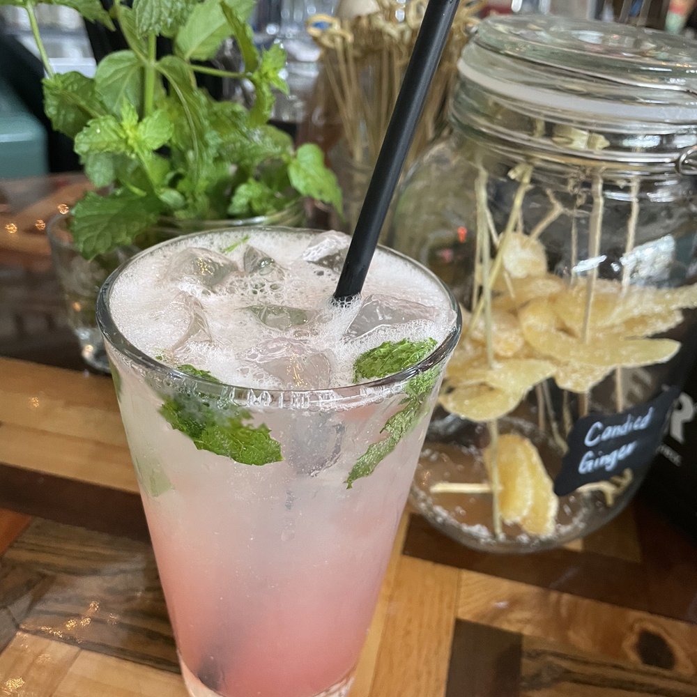 Fresh picked mint mojito with a splash of housemade watermelon purée. Fresh picked mint mojito with a splash of housemade watermelon purée.