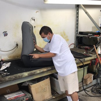 Ultra Trim Auto Restyling - Andrew removing factory seat covers to replace with leather. - Auto Upholstery Near Me - Carson, California