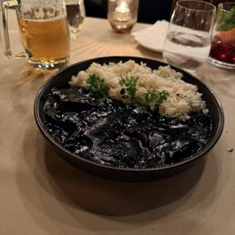 "Txipirones en su Tinta" - baby squid served in delicious squid ink sauce with rice, a generous portion for sharing "Txipirones en su Tinta" - baby squid served in delicious squid ink sauce with rice, a generous portion for sharing