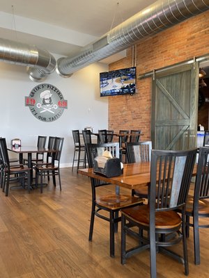 Photo of Greek’s Pizza - Martinsville, IN, US. tables and chairs in a restaurant
