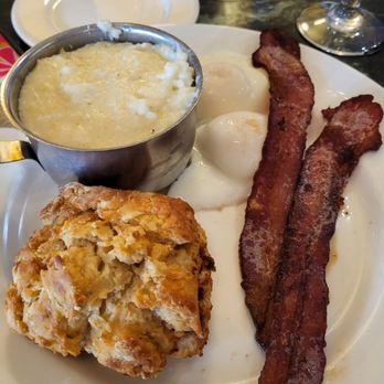 Palace Café - Side order; two strips of bacon, grits, two poached eggs and a muffin. - Cajun/Creole Near Me - New Orleans, Louisiana Palace Café - Side order; two strips of bacon, grits, two poached eggs and a muffin. - Cajun/Creole Near Me - New Orleans, Louisiana