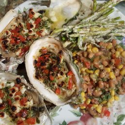One of my fresh oyster preps with Cava dressing & corn pico salsa & greens.