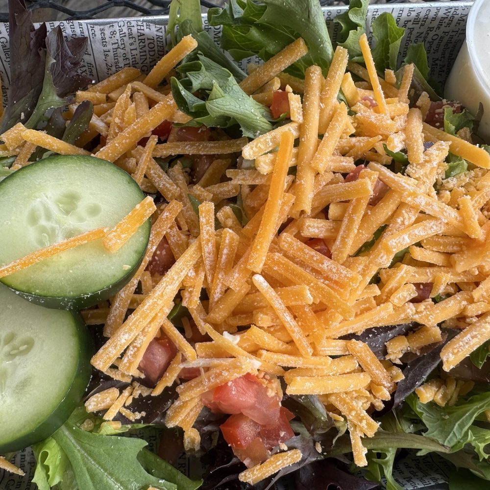 Salad with old powdery and hard shredded cheese. Salad with old powdery and hard shredded cheese.