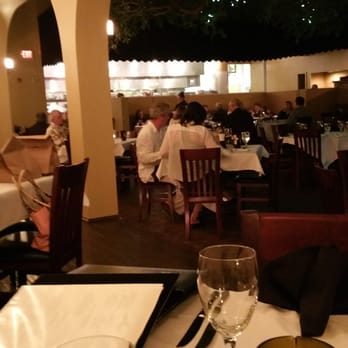 Firefly - Dining room with kitchen in backround, very elegant. - Steakhouses Near Me - Panama City Beach, Florida