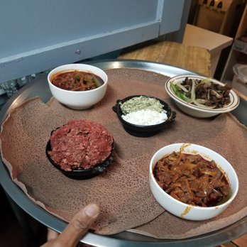 Ethio-LunchBox - a person holding a plate of food - Ethiopian Near Me - San Jose, California Ethio-LunchBox - a person holding a plate of food - Ethiopian Near Me - San Jose, California