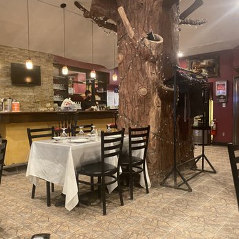 Miraj Healthy Grill - a dining area with a tree - Persian/Iranian Near Me - New York, New York Miraj Healthy Grill - a dining area with a tree - Persian/Iranian Near Me - New York, New York