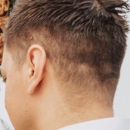 I forget the stylist's name, but she has tattoos and blonde highlights. This was my fiancé's haircut in our engagement photos.