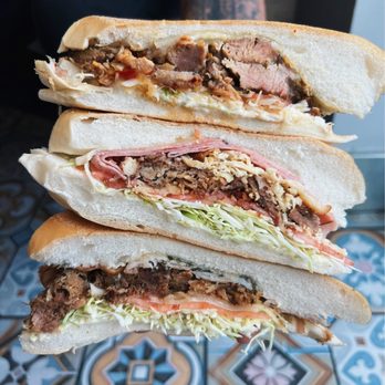 Meson Sandwiches - Top- Picante roast pork, Middle is the island trio and the bottom sandwich is the pavochon al mojo. - Breakfast & Brunch Near Me - Orlando, Florida Meson Sandwiches - Top- Picante roast pork, Middle is the island trio and the bottom sandwich is the pavochon al mojo. - Breakfast & Brunch Near Me - Orlando, Florida