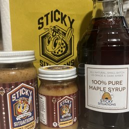 a jar of honey, a jar of syrup, and a jar of syrup