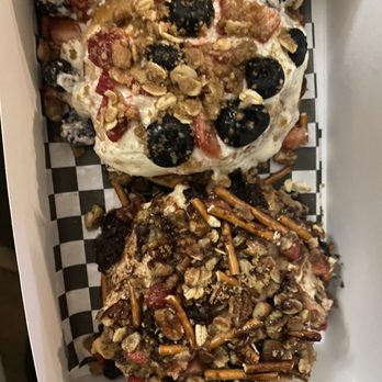 Cinnaholic - Custom cinnamon roll with peanut butter frosting, pretzels, pecans, brownie bites, strawberries. The other is American pie - Bakeries Near Me - Boca Raton, Florida