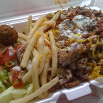 28th & Madison Halal Stand - Lamb over yellow rice with salad, dries, and a falafel - Food Trucks Near Me - New York, New York 28th & Madison Halal Stand - Lamb over yellow rice with salad, dries, and a falafel - Food Trucks Near Me - New York, New York