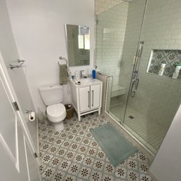 Bathroom with matching tiles on the floor and niche.