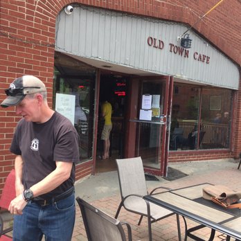 Old Town Cafe - Patio - Patio area of Old Town Cafe with outdoor tables, chairs, and patrons seated, along with a man standing nearby. - Bars Near Me - Wethersfield, Connecticut