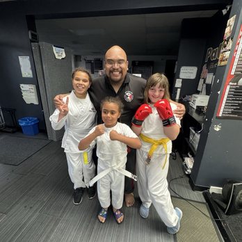 Pallen's Martial Arts - Sifu Jessie with two of his yellow belt graduates - Martial Arts Near Me - San Leandro, California Pallen's Martial Arts - Sifu Jessie with two of his yellow belt graduates - Martial Arts Near Me - San Leandro, California