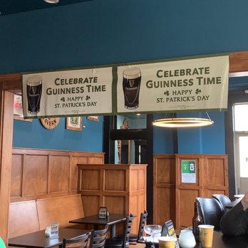 Three Spirits Tavern - a table and chairs in a pub - Cocktail Bars Near Me - Bellevue, Kentucky