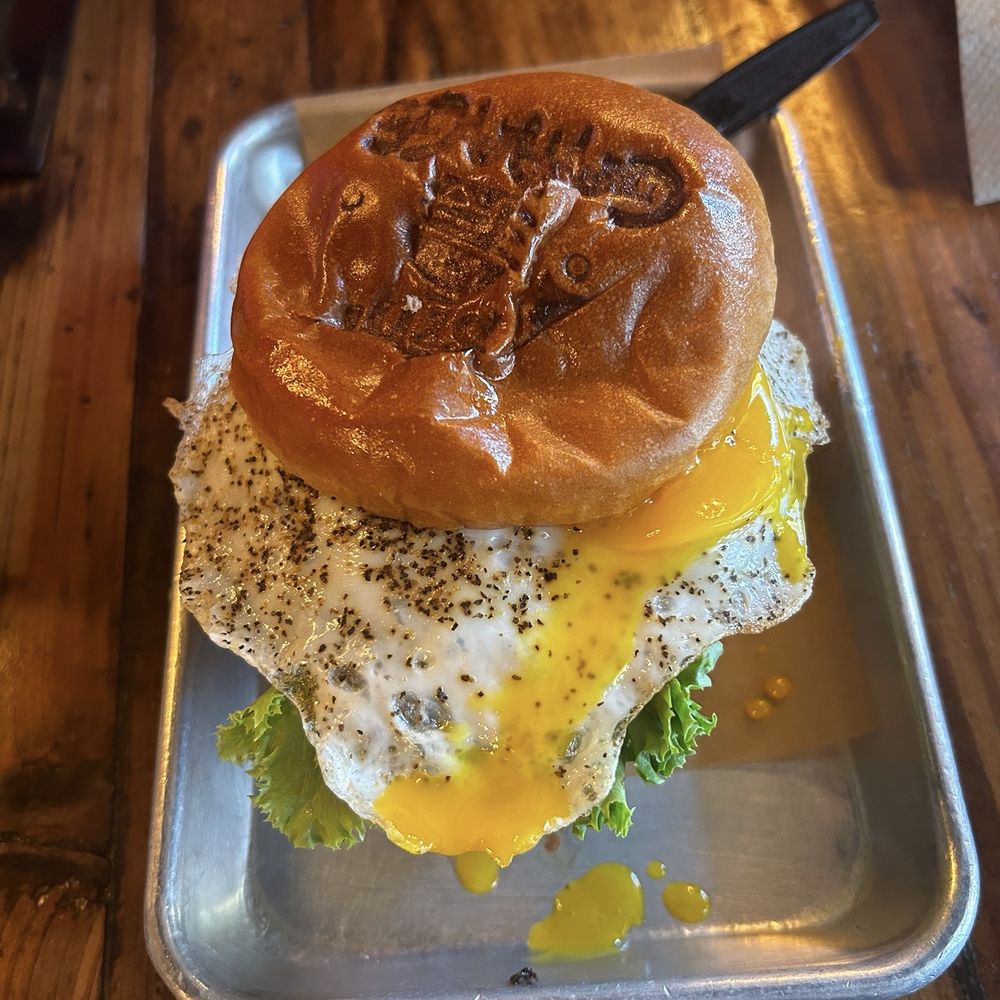 Sids Garage - The Godzilla burger. Three patties, fried egg, cheese, and lettuce. I didn't want the raspberry sauce it usually comes with. - Burgers Near Me - Meridian, Idaho Sids Garage - The Godzilla burger. Three patties, fried egg, cheese, and lettuce. I didn't want the raspberry sauce it usually comes with. - Burgers Near Me - Meridian, Idaho
