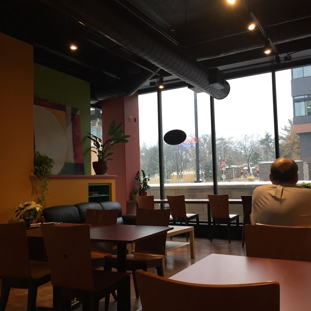 EVP Coffee - a man sitting at a table in a coffee shop - Coffee & Tea Near Me - Madison, Wisconsin EVP Coffee - a man sitting at a table in a coffee shop - Coffee & Tea Near Me - Madison, Wisconsin
