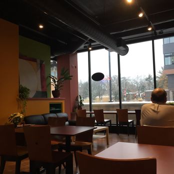 EVP Coffee - a man sitting at a table in a coffee shop - Coffee & Tea Near Me - Madison, Wisconsin