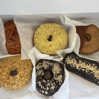 Old Ferry Donut - Top: creme brulee, butter pistachio, tiramisu Bottom: peanut butter, choco fudge glaze, Boston cream - Donuts Near Me - Buena Park, California