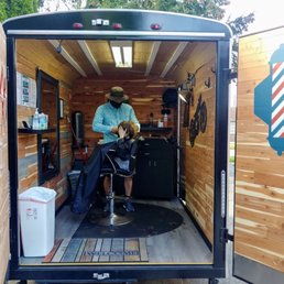 My son, getting a trim in the Barber Truck! My son, getting a trim in the Barber Truck!