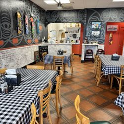 Killer Pizza - Restaurant seating and order window.