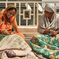 Anchal Project - Anchal artisans sewing quilts.