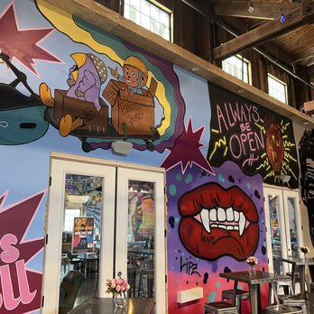 Wanderlust Wine - Shady Lane - a mural of a man on a skateboard - Wine Tasting Room Near Me - Austin, Texas Wanderlust Wine - Shady Lane - a mural of a man on a skateboard - Wine Tasting Room Near Me - Austin, Texas