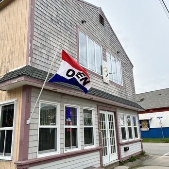 Ole Hookers East - a flag flying outside of a building - Salad Near Me - Eastport, Maine