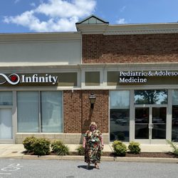 Infinity Pediatric & Adolescent Medicine - Dr. Baucom in front of new office