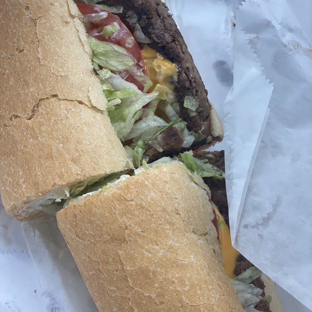 a large sandwich with meat and lettuce a large sandwich with meat and lettuce