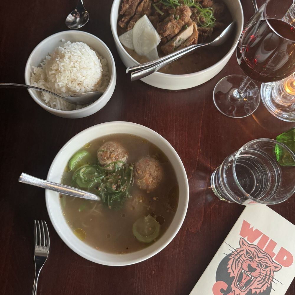 Wild Cat - top: wild cat fried chicken, white rice, and glass of red wine bottom: almondigas - Caterers Near Me - Seattle, Washington Wild Cat - top: wild cat fried chicken, white rice, and glass of red wine bottom: almondigas - Caterers Near Me - Seattle, Washington