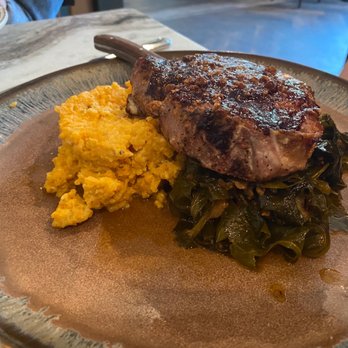 Crafted - Blueberry pork chop with grits and collards - American Near Me - Richmond, Virginia Crafted - Blueberry pork chop with grits and collards - American Near Me - Richmond, Virginia