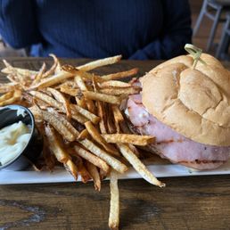 Cordon bleu burger medium rare with fries on too small a plate. Cordon bleu burger medium rare with fries on too small a plate.