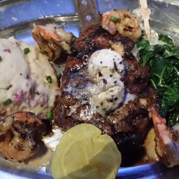 Saddle Ranch - Rib-Eye medium jumbo shrimp with garlic mash and spinach chasin it down with the house IPA...cooked to perfection. - Steakhouses Near Me - Orange, California Saddle Ranch - Rib-Eye medium jumbo shrimp with garlic mash and spinach chasin it down with the house IPA...cooked to perfection. - Steakhouses Near Me - Orange, California