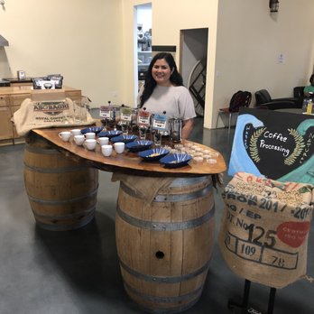 Fidalgo Coffee Roasters - a woman standing behind a barrel of coffee - Coffee Roasteries Near Me - Burlington, Washington Fidalgo Coffee Roasters - a woman standing behind a barrel of coffee - Coffee Roasteries Near Me - Burlington, Washington