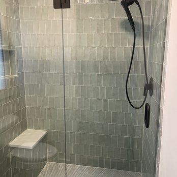 Sapphire Tile - Custom shower tile with quartz benchtop, slate curb, and penny tile mosaic shower floor. - Demolition Services Near Me