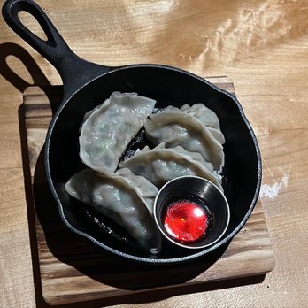 Tanma Ramen - a skillet with dumplings and a spoon - Ramen Near Me - Kingston, New York Tanma Ramen - a skillet with dumplings and a spoon - Ramen Near Me - Kingston, New York