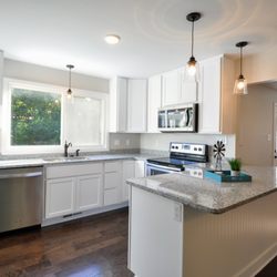 A G Smart Home Builders - Deerwood House: New window, cabinets, flooring, and appliances